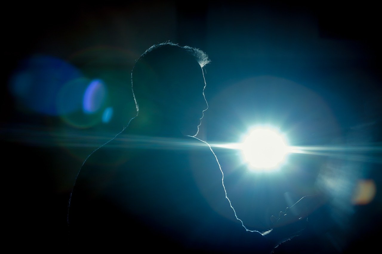 man standing in-front of focus light